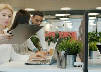 Colleagues collaborating in a modern office environment.